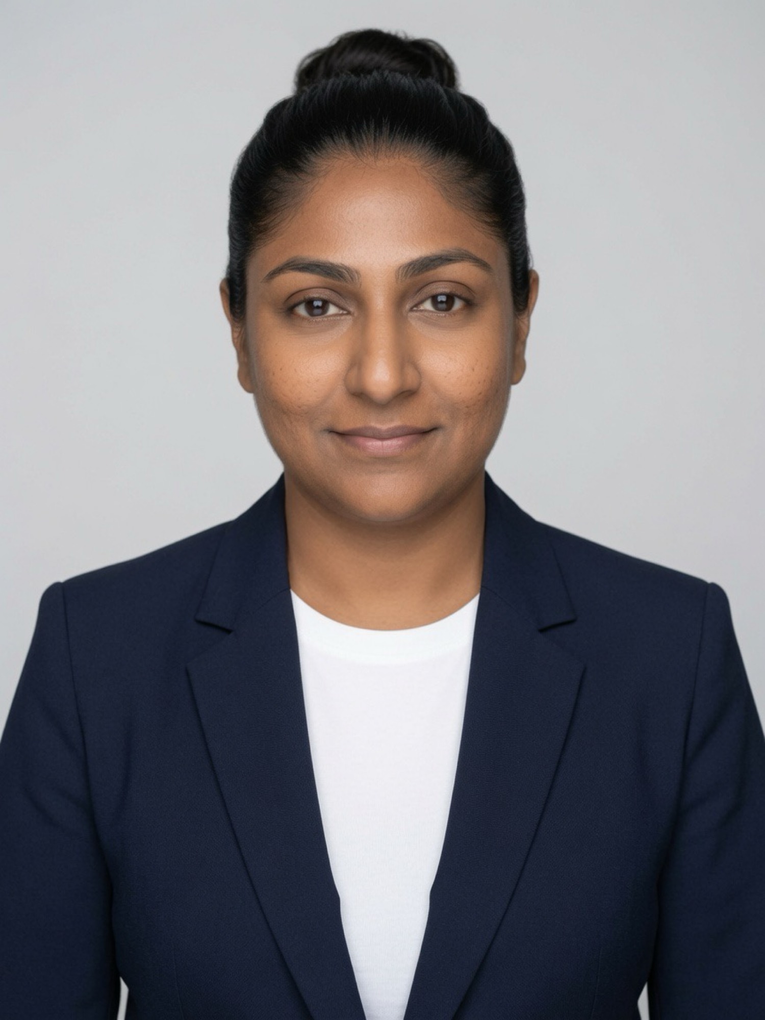 Black-and-white portrait of Bina Atman in a blazer